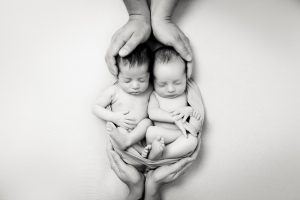 Snuggled newborn twins together