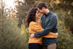 Couple embraces each other in Los Gatos Tree Farm